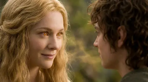 Goldberry\'s face in soft focus looking at Frodo with eyes that see beyond the physical, gentle light surrounding them, her expression knowing and kind